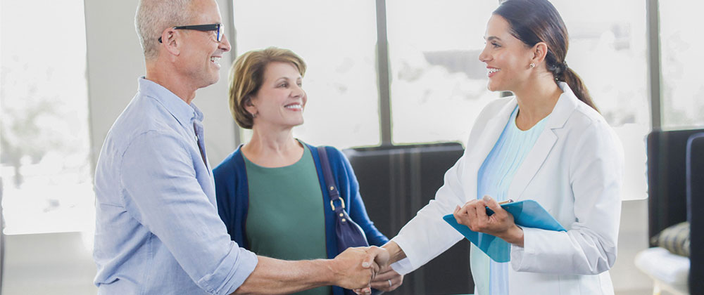 Couple in Clinic Shaking Hands with Professional